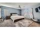 Spacious bedroom with ceiling fan, carpet flooring, and plenty of natural light at 5599 Valley Mill St, Las Vegas, NV 89148