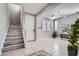 Bright and airy entryway with tile flooring and staircase at 5599 Valley Mill St, Las Vegas, NV 89148