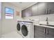 Bright laundry room with modern washer, dryer and cabinets at 5599 Valley Mill St, Las Vegas, NV 89148