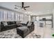 Open living room showcasing a sectional sofa and a view into the kitchen area at 5599 Valley Mill St, Las Vegas, NV 89148