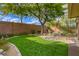 Landscaped backyard with artificial turf and mature tree at 5741 Pleasant Palms St, North Las Vegas, NV 89081