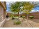 Landscaped backyard with mature trees and gravel at 5741 Pleasant Palms St, North Las Vegas, NV 89081