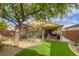 Backyard with covered patio, landscaping and mature tree at 5741 Pleasant Palms St, North Las Vegas, NV 89081