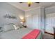 Spacious bedroom with striped bedding and built-in closet at 5741 Pleasant Palms St, North Las Vegas, NV 89081