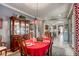 Spacious dining room with a red tablecloth and view into the kitchen at 5741 Pleasant Palms St, North Las Vegas, NV 89081