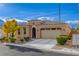 Tan single story home with a two car garage and desert landscaping at 5741 Pleasant Palms St, North Las Vegas, NV 89081