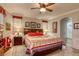 Main bedroom features a king bed, ceiling fan, and a view into the bathroom at 5741 Pleasant Palms St, North Las Vegas, NV 89081