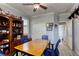 Home office with a wooden desk, blue chairs, and built-in shelving at 5741 Pleasant Palms St, North Las Vegas, NV 89081