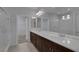 Double vanity bathroom with a large mirror and glass shower at 5977 Ancient Peaks Ave, Las Vegas, NV 89141