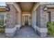 Inviting entryway with a wrought iron door and stone pillars at 5977 Ancient Peaks Ave, Las Vegas, NV 89141