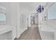 Elegant bathroom with soaking tub, chandelier, and walk-in shower at 6364 Cambridge Creek Ct, Las Vegas, NV 89149