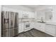 Well-lit kitchen with white cabinets, stainless steel refrigerator and modern appliances at 6382 Lonesome Lake St, Las Vegas, NV 89148