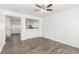 Open-concept living area with contemporary flooring, neutral wall color, and a pass-through kitchen view at 6382 Lonesome Lake St, Las Vegas, NV 89148