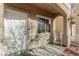 Inviting porch featuring a white front door, textured exterior, and comfortable seating at 6382 Lonesome Lake St, Las Vegas, NV 89148