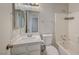 Clean bathroom with white vanity, bathtub, and tiled floors at 6560 Bush Clover Ln, Las Vegas, NV 89156