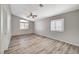 Spacious bedroom with wood-look floors and ceiling fan at 6560 Bush Clover Ln, Las Vegas, NV 89156