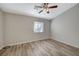 Well-lit bedroom with wood-look floors and ceiling fan at 6560 Bush Clover Ln, Las Vegas, NV 89156