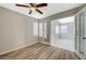 Bedroom with wood-look floors, French doors to sunroom, and ceiling fan at 6560 Bush Clover Ln, Las Vegas, NV 89156