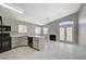 Modern kitchen with white cabinets and black appliances at 6560 Bush Clover Ln, Las Vegas, NV 89156