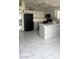 Kitchen features gray cabinets, an island, and tile flooring at 6560 Bush Clover Ln, Las Vegas, NV 89156