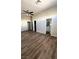 Main bedroom with wood-look flooring and an ensuite bathroom at 6560 Bush Clover Ln, Las Vegas, NV 89156