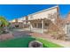 Landscaped backyard with covered patio and fire pit at 6607 Musette Ave, Las Vegas, NV 89139