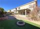 Home with covered patio, fire pit, and artificial turf at 6607 Musette Ave, Las Vegas, NV 89139