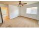 Well-lit bedroom with ceiling fan and access to hallway at 6607 Musette Ave, Las Vegas, NV 89139