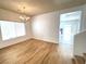 Dining room with hardwood floors, chandelier, and view to kitchen at 6607 Musette Ave, Las Vegas, NV 89139