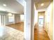 Hallway with tile and wood flooring, leading to laundry room at 6607 Musette Ave, Las Vegas, NV 89139