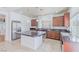 Kitchen with dark wood cabinets, granite countertops, and island at 6607 Musette Ave, Las Vegas, NV 89139