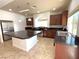 Modern kitchen with granite island and stainless steel appliances at 6607 Musette Ave, Las Vegas, NV 89139