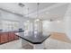 Kitchen with dark wood cabinets, granite countertops and island at 6607 Musette Ave, Las Vegas, NV 89139