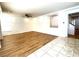 Bright living room with wood-look floors and access to kitchen at 6607 Musette Ave, Las Vegas, NV 89139