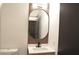 Modern bathroom with an oval mirror and a light brown vanity at 7409 Flat Rock St, Las Vegas, NV 89131