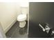 Clean bathroom with toilet and dark-tiled floor at 7409 Flat Rock St, Las Vegas, NV 89131