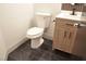 Clean bathroom with dark tile floor and a white toilet at 7409 Flat Rock St, Las Vegas, NV 89131