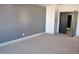 Spacious bedroom with gray shiplap accent wall and carpet at 7409 Flat Rock St, Las Vegas, NV 89131