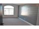 Spacious bedroom with gray shiplap accent wall and carpeted floor at 7409 Flat Rock St, Las Vegas, NV 89131