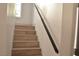 Modern stairs with a simple black handrail at 7409 Flat Rock St, Las Vegas, NV 89131