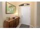 Bright entryway with wood console table and large world map art at 750 Arguello Cir, Mesquite, NV 89027