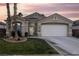 Single-story home with a two-car garage and landscaped yard at 750 Arguello Cir, Mesquite, NV 89027