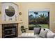 Cozy living room fireplace with marble surround and large window at 750 Arguello Cir, Mesquite, NV 89027