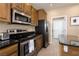 Modern kitchen with stainless steel appliances and granite countertops at 750 Arguello Cir, Mesquite, NV 89027