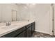 This bathroom offers double sinks, dark cabinetry, and an updated faucet at 762 Star Estates Ave, North Las Vegas, NV 89086