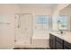 Bright bathroom features a shower with glass door, and tiled flooring at 762 Star Estates Ave, North Las Vegas, NV 89086
