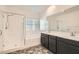 Modern bathroom featuring a double vanity, large mirror, soaking tub and separate glass enclosed shower at 762 Star Estates Ave, North Las Vegas, NV 89086