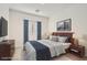 This primary bedroom boasts a large bed, blue drapes and complementary brown furniture at 762 Star Estates Ave, North Las Vegas, NV 89086