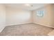 Bright bedroom with plush carpeting, neutral walls, and a window providing ample natural light at 762 Star Estates Ave, North Las Vegas, NV 89086