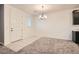 Dining area with neutral color palette, tile floor and chandelier at 762 Star Estates Ave, North Las Vegas, NV 89086